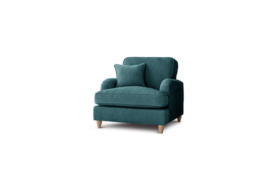 Teal armchair with a cushion on a white background